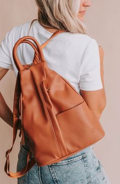 We are always looking for a bag that everyone will love. This might just be it! Enter our convertible backpack. This bag comes with a stylish clever zipper strap, it goes from backpack to crossbody, has a convenient top handle and can even be wore on the shoulder. It's the middle ground between our Hazel and Nikki. Yes, this bag is just that good!! Bag Details: Made with Premium Vegan Leather Dims: 11" BASE 4" TOP W X 13.5" H X 5.5" D Weight: 1.12 lbs. Exterior Features: 1 Front Padded Pocket 1 Bag Details, Convertible Backpack, A Bag, Leather Backpack, The Middle, Top Handle, Convertible, Vegan Leather, Brooklyn