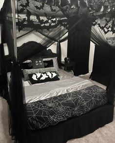 a bed with black and white decorations on it's headboard, made to look like a canopy