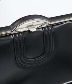 This stunning accessory features a classic black design that’s perfect for adding a touch of elegance to any outfit. With its stylish attached top handle and a removable crossbody strap, you can easily switch between chic and casual looks in an instant. The secure top snap closure keeps your essentials safe, while two inner zip pockets and one slip pocket offer ample organization for your treasures.Available while supplies last. Black Design, Crossbody Strap, Unique Vintage, Snap Closure, Classic Black, Top Handle, Casual Looks, Zip Pockets, Handbags