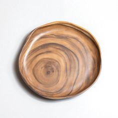 a wooden plate sitting on top of a white table