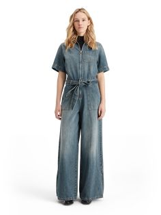 Make a bold statement with our Washed Denim Workwear Jumpsuit. Constructed from 100% cotton, this jumpsuit combines durability and style seamlessly. Wear it with chunky sneakers for a casual daytime look or dress it up with stilettos for a night on the town. Versatile and effortlessly cool, this jumpsuit is a must-have. 100% Cotton Wash - 30 Degrees Delicate Trendy Wide-leg Cotton Jumpsuits And Rompers, Trendy Wide Leg Cotton Jumpsuits And Rompers, Trendy Wide-leg Cotton Jumpsuit, Trendy Cotton Wide Leg Jumpsuits And Rompers, Utility Style Denim Jumpsuit With Relaxed Fit, Utility Denim Jumpsuit With Short Sleeve And Relaxed Fit, Relaxed Fit Denim Jumpsuit For Work With Short Sleeves, Chic Cotton Denim Jumpsuit With Relaxed Fit, Relaxed Fit Cotton Denim Jumpsuit With Short Sleeves