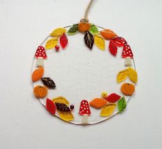 a glass ornament decorated with autumn leaves