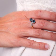 a close up of a person's hand with a ring on her left hand