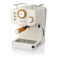 an espresso machine is shown on a white background with the clock displayed above it