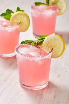 two glasses filled with pink lemonade and mint garnish