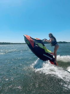 a woman riding on the back of a jet ski