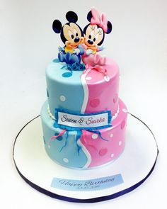 two mickey and minnie mouse cakes on a plate