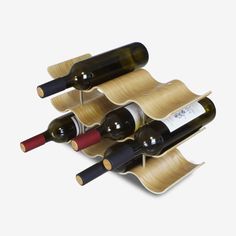 three bottles of wine are stacked on top of each other in the shape of a wave