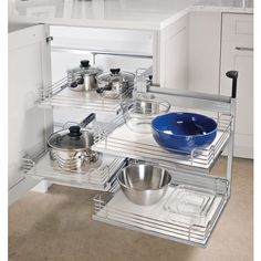 two shelves with pots and pans on them in the middle of a kitchen area