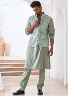 Embroidered kurta set with bundi jacket. Luxury Pista Green Nehru Jacket With Zari Work, Spring Nehru Jacket With Intricate Embroidery, Spring Festive Cotton Silk Sherwani, Designer Cotton Silk Pant Set, Spring Bandhgala With Chikankari Embroidery, Unstitched Chikankari Embroidery Nehru Jacket For Spring, Designer Spring Kurta With Cutdana, Spring Designer Kurta With Cutdana, Anarkali Style Cotton Sherwani With Intricate Embroidery