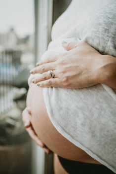 a pregnant woman's hand on her belly