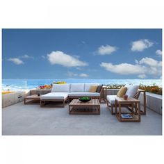 an outdoor living area with white furniture and blue sky