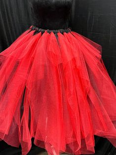 This one of a kind red and black vintage style tutu was created by winsome Fashions  formal semi formal and casual  wear. . This tutu has added volume , it is  extra full and  Multi-Layered  to enhance its  uniqueness!  Several lengths to choose from!  These gorgeous tutu skirts are carefully Handmade from 100% fine Polyester material . Comfortable 1 inch satin covered  Elastic Waistband. Lightweight and fun to wear! Please message Winsome for further questions , thanks Red Tutu, Tutu Skirts, Pumpkin Costume, Tulle Tutu Skirt, Tutu Skirt, Black Accents, Vibrant Red, Vintage Stil, Semi Formal