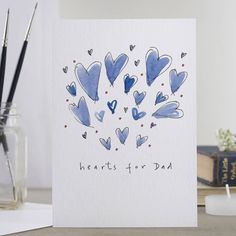 a card with blue hearts and the words hearts for dad written on it in black ink