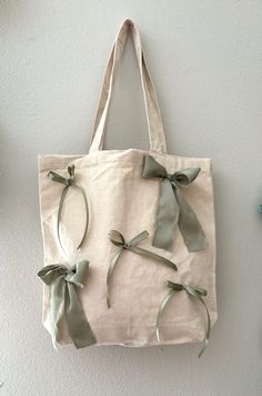 a tote bag with bows hanging on the wall