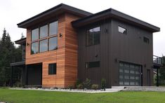 a modern house with wood siding and windows