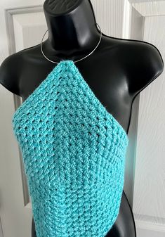 a crocheted blue top on a mannequin