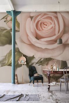 a living room with a wall mural that has a pink rose on it