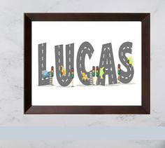 the word lucas spelled in grey letters on a white marble wall with a wooden frame