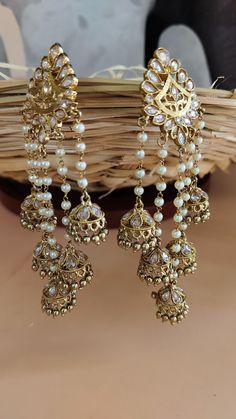 Antique Gold Long Kundan Polki Earrings Bahubali Inspired | Fashion Earrings | Wedding gift | Bridal Earring | Gold Plated long Earring We bring you casual as well as party wear jewelry which comes with an attractive design and helps in boosting your style factor. A classic fusion of exquisite craftsmanship and elegance, this jewelry tries to make you look graceful and stylish when paired with your attire. It goes well with modern and traditional outfits.  These Earrings are made of Alloy, Pure Copper and Kundan and Pearls . Trust me the quality of Earrings is the Best  Women love jewelry; specially traditional jewelry adore a women. They wear it on different occasion. They have special importance on ring ceremony, wedding and festive time. They can also wear it on regular basics. Make you Bridal Earring, Indian Jewelry Earrings, Long Earring, Polki Earrings, Valentine Gifts For Girlfriend, Gold Bridal Earrings, Earring Gold, Earrings Wedding, Inspired Fashion