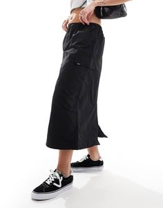 Skirts by Vans Give your pants a day off High rise Stretch-back waistband Functional pockets Regular fit Black Nylon Lined Skirt, Utility Skirt With Elastic Waistband, Casual Long Skirt With Side Pockets, Utility Style Long Skirt With Cargo Pockets, Utility Cargo Skirt With Elastic Waistband, High-waisted Black Cargo Skirt For Streetwear, Casual Long Cargo Skirt With Side Pockets, Utility Black Skirt With Cargo Pockets, Solid Color Cargo Skirt With Pockets