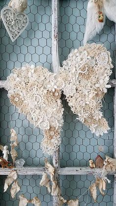 an old window is decorated with birds and feathers