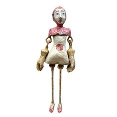 a wooden doll with long legs and a pink dress on it's head is standing in front of a white background