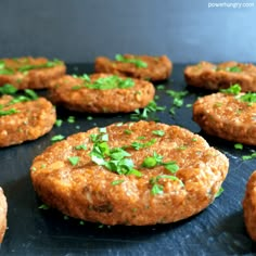 baked red lentil kefta on a baking sheet with green garnishes