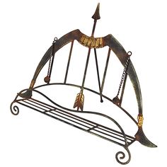 a metal rack with two arrows on it's sides and an arrow hanging from the top