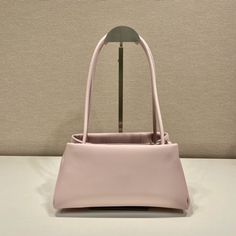 SHOP MORE LUXURY PRODUCTS HERE Description Prada Small Bag Pink For Women, Women’s Bags 9.8in/25cm A study of the lines characterizes this smallÃƒÂ¯Ã‚Â¿Ã‚Â½ÃƒÂ¯Ã‚Â¿Ã‚Â½ÃƒÂ¯Ã‚Â¿Ã‚Â½ÃƒÂ¯Ã‚Â¿Ã‚Â½ handbag. It stands out for its absolutely elegant silhouette emphasized by the long, narrow handle. This three-pocket accessory is decorated with the metal lettering logo. Size: 25 x 13.5 x 13 cm /9.8 x 5.3 x 5 inches (Length x Width x Height) PinkHandlesMetal hardwarePrinted lettering logo on the fr Pink Baguette Bag For Shopping, Classic Square Baguette Bag For Shopping, Pink Rectangular Baguette Bag With Top Carry Handle, Pink Rectangular Baguette Bag With Top Handle, Classic Baguette Shoulder Bag For Shopping, Modern Baguette Bag For Daily Use With Dust Bag, Pink Office Box Bag With Removable Pouch, Formal Square Pink Shoulder Bag, Formal Pink Square Shoulder Bag