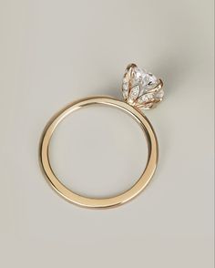 an engagement ring with a pear shaped diamond