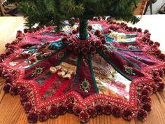 a christmas tree skirt sitting on top of a wooden table