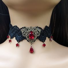 This vintage gothic styled crystal choker necklace features captivating Siam Red Swarovski crystals with nice crisp facets and brass embellishments. The detailed stampings have been in production since the 1940's and the vintage 16x11mm focal crystal is no longer in production, making this necklace a rare find. The lace is double-layered and hand sewn together for extra durability. Both elegant and stylish, this piece would be perfect for any formal occasion. Swarovski Crystals are made in Austr Vintage Jeweled Choker As Gift, Vintage Jeweled Choker Gift, Vintage Metal Choker With Jewels, Vintage Red Choker For Party, Elegant Costume Jewelry Choker, Vintage Jeweled Choker, Vintage Jeweled Choker For Parties, Gothic Crystal Jewelry For Gift, Vintage Red Choker Jewelry