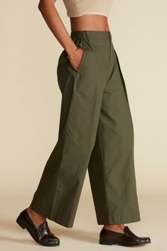 Strictly business or weekend casual, these summer-weight cropped pants add effortless style with a dramatically wide leg, high waist, and pockets—naturally. High-waisted, wide-leg , cropped pant with pleat details at front Zipper fly with hook and bar at waist, elastic on sides for fit 100% Organic Cotton Poplin 14" rise 26" in Length Ethically Made in Peru Part of a matching set Strictly Business, Olive Green Pants, Navy Outfit, Pant Trends, Green Pants, Cotton Poplin, Cropped Pants, Effortless Style, Front Zipper