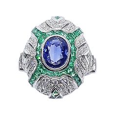 Blue Sapphire 1.49 carats with Emerald 2.44 carats and Diamond 0.48 carat Ring set in 18 Karat White Gold Settings Width: 0.7 cm Length: 0.9 cm Ring Size: 51 Total Weight: 8.3 grams "We first opened doors in 1980 when it was then situated in the vicinity of the Victory Monument; a small and modest storefront with a couple of counters. From its humble beginnings to where it stands today, our company has proven its abilities as a jeweler. Since the beginning, we have been supplying fine quality pi Diamond Cuff Ring, Emerald And Diamond Ring, Diamond Ring Set, Retro Ring, Emerald Diamond Ring, White Gold Set, White Diamond Ring, Diamond Ring Settings, Gold Ring Sets