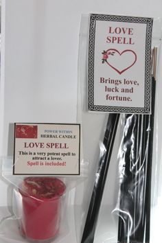 some sort of love spell on display in a bag with two sticks and a cup