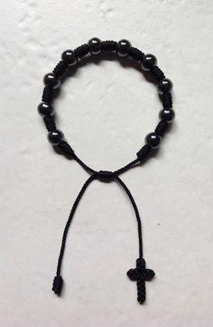 Made of hematite beads of 8mm, strong resistant material we have in black and red yarn, its $6.00 each bracelet and this is perfect for praying on the go. Celebrity Bracelets, Diy Jewelry Charms, Catholic Bracelet, Kabbalah Bracelet, Crystal Earrings Wedding, Halloween Bracelet, Catholic Jewelry, Black Bracelet, Red Yarn