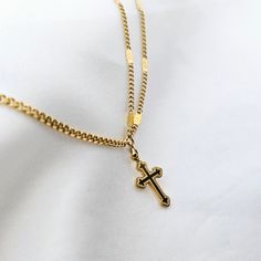 Cross charm pendant with an irregular double chain style. The disc chains in 18k tarnishfree gold reflect the light beautifully and the cross pendant has been given a vintage feel with a patterned carved design on it. Grab it while on a promotional Price! Comes with a standard 45cm + 5cm extender gold chain. Material: 18 Carat Gold plating over stainless steel makes this non-tarnish, fade proof metal, hypoallergenic Packaging & Delivery: Your item will arrive carefully, lovingly wrapped in a branded gift box, toffees and laces.Gift wrapping available for all occasions, just leave a note :) perfect for giving or keeping! Delicate Chain Necklace With Cross Pendant, Cross Pendant Chain Necklace, Minimalist Cross Chain Necklace With Delicate Chain, Dainty Tarnish Resistant Cross Pendant Necklace, Minimalist Delicate Chain Cross Necklace, Dainty Tarnish-resistant Cross Pendant Necklace, Figaro Chain Cross Pendant Necklace For Gift, Minimalist Gold Chain Necklace With Cross Pendant, Yellow Gold Cross Charm Necklace With Delicate Chain