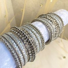 Stunning Silvery shimmer bangles. Sparkle at any occasion with this silver base, silver crystal and glittery midi bangle set for both arms! Includes 16 bangles with a statement kada bangle in middle. Length approx 2.5 inch for each arm.  Ready to ship 📦 Stackable Bangle For Parties, Silver Crystal Bracelet For Party, Glamorous Silver Sparkling Crystal Bracelet, Glamorous Sparkling Silver Crystal Bracelet, Silver Stackable Crystal Bracelet For Wedding, Stackable Silver Crystal Bracelet For Wedding, Stackable Round Bangle For Party, Silver Stackable Crystal Bangle Bracelet, Silver Crystal Bangle Bracelet For Party