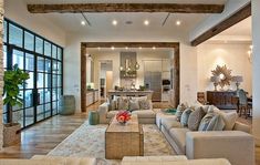 a living room filled with furniture and lots of windows