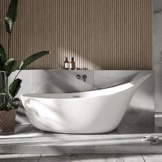 a large white bath tub sitting on top of a bathroom floor next to a plant