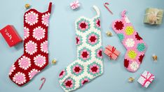 crocheted christmas stockings and decorations on a blue background