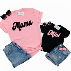 Mama and Mini set of 2 matching tees! Professionally screen printed. Retro style font. MAMA is printed on a standard adult unisex tee made of 100% cotton. Shirt color is Pink. Print color is Black. Fits true to size. Unisex sizing. We recommend ordering the same size you normally wear in an adult unisex shirt. If you want more of a fitted look, order one size down. Refer to Product Images for Size Chart with chest measurements. MINI is printed on your choice of a one-piece bodysuit for baby or a Cute Cotton T-shirt With Name Print, Cute Pink T-shirt With Funny Text, Unisex Cotton T-shirt For Family Occasions, Pink Graphic Print T-shirt For Mother's Day, Cute Cotton T-shirt For Family, Family Matching Pink T-shirt With Letter Print, Pink Family Matching T-shirt With Letter Print, Pink Family Matching Graphic T-shirt, Trendy Pink Top For Mother's Day