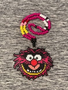 Mini perler Kandi necklace with Animal from The Muppet Show design! Matching chain. Beaded Chain Necklace For Festivals And Gifts, Themed Multicolor Necklace For Gift, Handmade Red Necklaces For Birthday, Pink Beaded Necklace Chain As Gift, Pink Beaded Necklace With Chain As Gift, Multicolor Pendant Necklace For Birthday, Handmade Red Necklace For Birthday, Handmade Fun Necklaces For Gifts, Fun Necklaces With Lobster Clasp For Gift