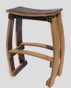 a wooden stool with metal studs on the seat and backrest is shown in this image