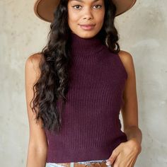 An Elevated Take On Everyday Staples, The Whitlie Sleeveless Mock Neck Sweater Is A Fall Must-Have! This Sleeveless Sweater Is Draped In A Beautiful Plum Color And Is Ribbed Throughout. Pair With Jeans And A Hat For An Upgraded Look. Model Is Wearing Size S Model Height: 5'10" Hand Wash Cold Plum Winter Ribbed Vest, Ribbed Vest For Fall, Trendy Turtleneck Tank Top For Fall, Sleeveless Ribbed Winter Top, Sleeveless Ribbed Top For Winter, Winter Sleeveless Ribbed Vest, Ribbed Sleeveless Winter Vest, Fall Season High-neck Ribbed Tank Top, Winter Ribbed Sleeveless Vest