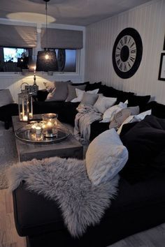 a living room filled with lots of furniture and candles on top of it's coffee table