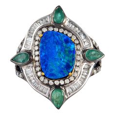 This stunning ring has been meticulously crafted from 18-karat gold and sterling silver. It is centered with 2.46 carats opal, .94 carats emerald and illuminated with .85 carats glittering diamonds. The ring is a size 7 and may be resized to larger or smaller upon request. FOLLOW MEGHNA JEWELS storefront to view the latest collection & exclusive pieces. Meghna Jewels is proudly rated as a Top Seller on 1stDibs with 5 star customer reviews. All items manufactured by us are handmade and can be cus Luxury Green Opal Heirloom Ring, Luxury Heirloom Green Opal Ring, Vintage Opal Diamjnd Emerald Ring, Luxury Green Opal Gemstone Ring, Luxury Green Heirloom Opal Ring, Luxury Green Opal Ring, Luxury Green Opal Ring With Diamond, Opal And Diamond Ring, Crossover Diamond Ring