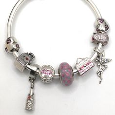 -Authentic Pandora Bracelet ‘Fairies & Pink Polka-Dots’ -Shown On 19cm Ball Clasp Pandora Bangle -Avail In Other Sizes In Various Styles Pls Ask If Need -Fairies & Pink Polka-Dots Design Comes With X1 Authentic Pandora Charm Pandora Pink Polka-Dot Murano Bead 925 Ale -Plus Mix 925ss & 525ss Charms: Perfume Bottle ‘I Love Shopping’ 925ss Kiss Lips Charm 925 Pink Polka-Dot Purse 925 Fairy Dangle 925 Champagne Bottle 525ss Pink Qrtz Pave Rose Charm 525ss X2 Pink Heart On Heart Charm 525ss -Pls Note: 525ss Charms Are Made Extremely Well Compared To Regular Plated Charms. Made With 52.50% Silver Not 92.50% But Last Just As Long And Almost Just As Durable. Fine Jewelry Silver Round Beads Jewelry, Fine Jewelry Silver Round Beads, Sterling Silver Charms Jewelry For Party, Silver Charms For Gifts In Fine Jewelry Style, Silver Charms For Gifts, Fine Jewelry Style, Silver Beaded Bracelets In Fine Jewelry Style, White Gold Sterling Silver Bangle Beaded Bracelet, Charm Bracelet With Spacer Beads As Gift, Silver Charm Bracelets For Party