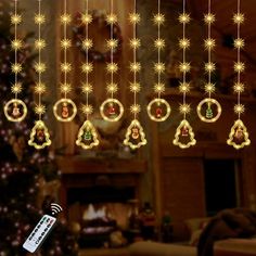 christmas decorations hanging from the ceiling in front of a fireplace with a tv remote control